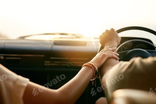 Preview: Young couple in their car holding hands