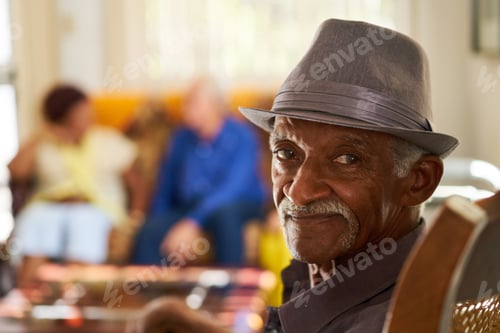 Preview: Senior Black Man With Hat Looking At Camera In Hospice