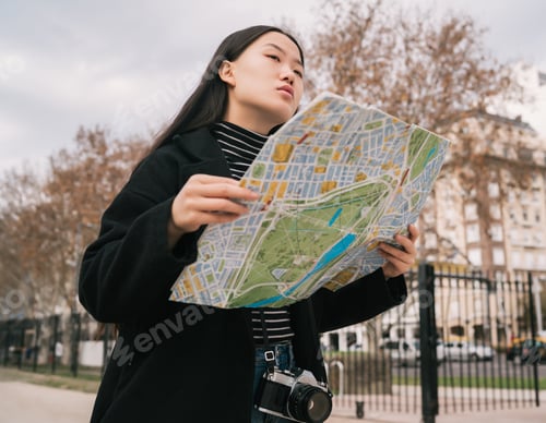 Preview: Young asian woman with a map.