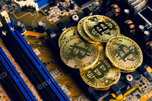 Preview: Golden coins with bitcoin symbol on a mainboard.