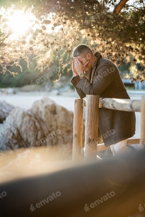 Preview: Man watching the sea with mountains on the background