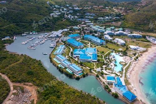 Preview: an aerial view of an island with a boat dock and many different houses