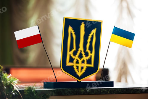 Preview: meeting Ukraine and Poland. flags of Poland and Ukraine and trident between on the negotiating table