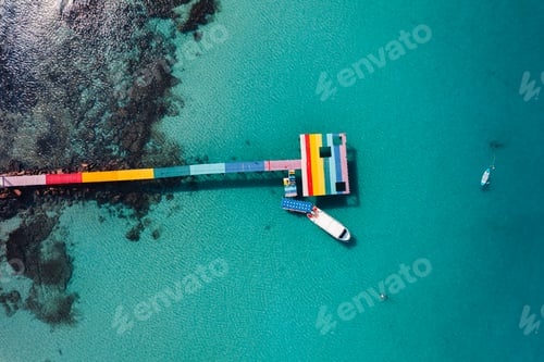 Preview: Wooden bridge at the beach and clear blue water