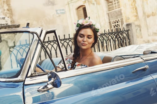 Preview: Beautiful woman driving a retro convertible car