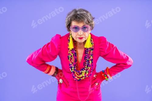 Preview: Happy and funny senior old woman on colorful background