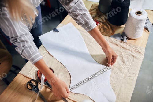 Preview: dressmaker working with measuring tape
