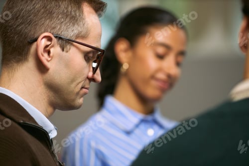 Preview: Caucasian Young Adult Man Collaborating with Multiethnic Colleagues in Office
