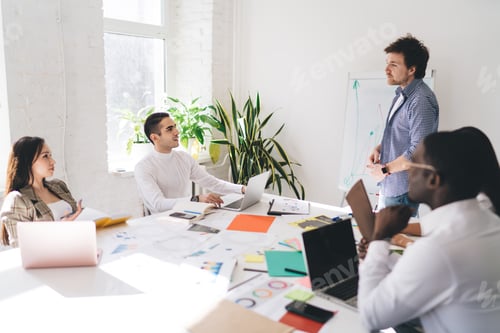 Preview: Diverse colleagues discussing presentation of business strategy