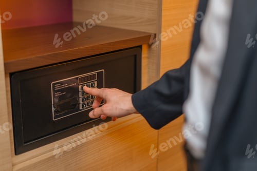 Preview: A hand enters a code to open and lock a safe or safe in hotel room Theft or keeping valuables