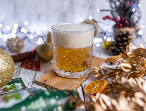 Preview: Glass of Christmas beer served with beautiful bright decorations
