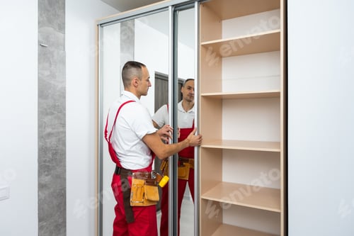 Man Installing New Closet in Bright Room