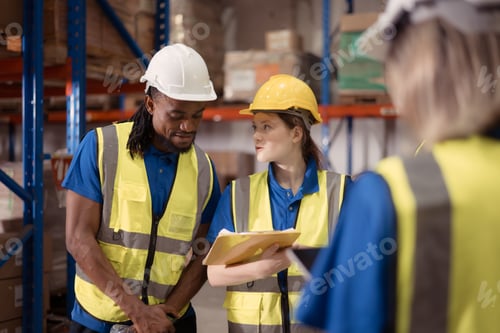 Preview: Side view of warehouse workers discussing inspecting goods brought into the warehouse