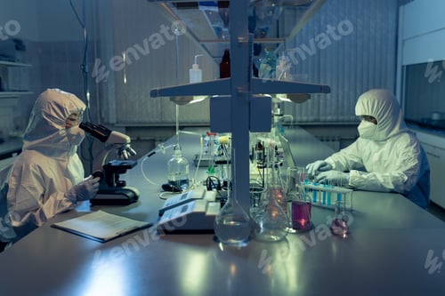 Preview: Two contemporary lab workers in coveralls