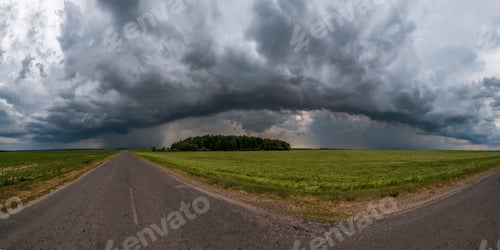 Preview: hdr panorama on asphalt road among fields in evening with awesome black clouds before storm