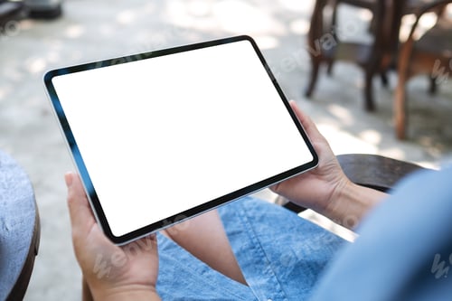 Preview: Mockup image of a woman holding digital tablet with blank white desktop screen in the outdoors