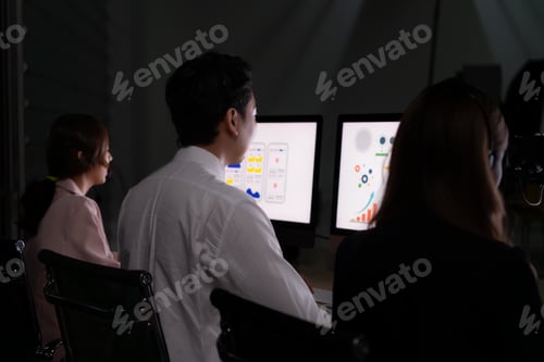 Preview: Portrait of young Asian business man working on laptop in night at office