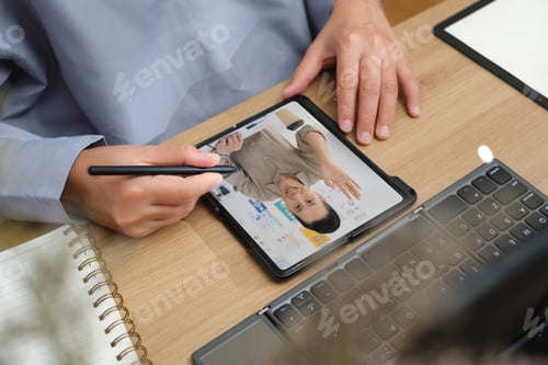 Preview: asian woman use mobile while video conference meeting online with tablet at home
