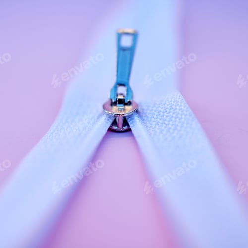 Preview: Closeup of a metal zip isolated on a pink background. Macro view of a zipper closing or being unzip