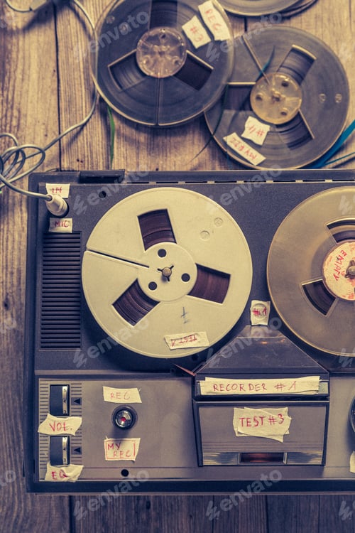 Preview: Top view of old reel audio recorder and roll tapes