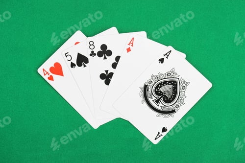 Preview: top view of green poker table and unfolded playing cards with different suits