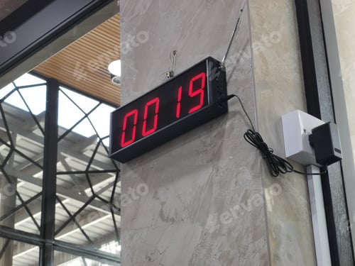 Preview: Image of queue management system device display on the shop wall.