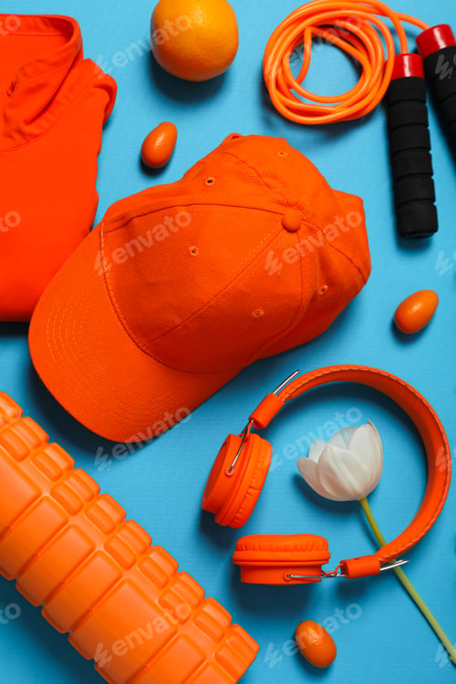 Preview: Sportswear and accessories, with flowers, on a blue background.