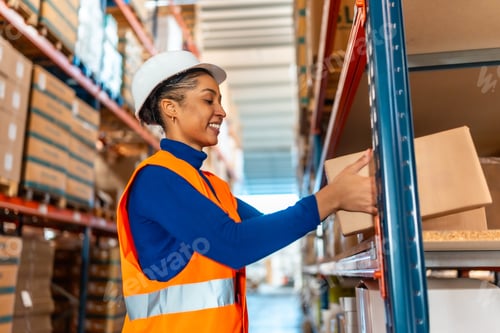 Preview: Happy woman worker organizing inventory in logistics warehouse