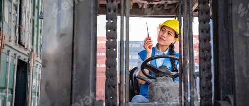 Preview: Engineer or foreman working and use talkie with a forklift in at container yard.