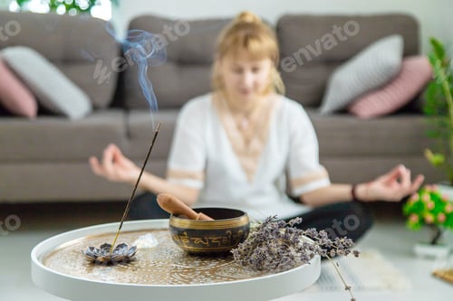 Preview: Woman doing yoga at home and aromatherapy. Selective focus.