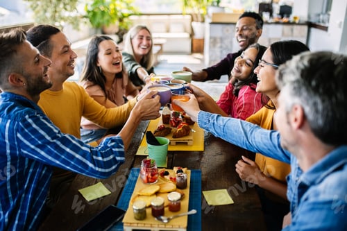 Vista previa: Smiling multiracial group of young people having breakfast together