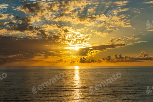 Preview: Beautiful sunset over endless sea with reflection in the water