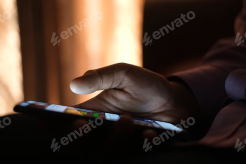 Preview: Close up of young man hand using smart phone at night