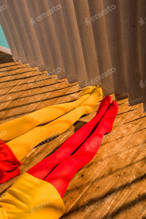 Preview: cropped image of girls in red and yellow tights and dresses sitting on floor at home
