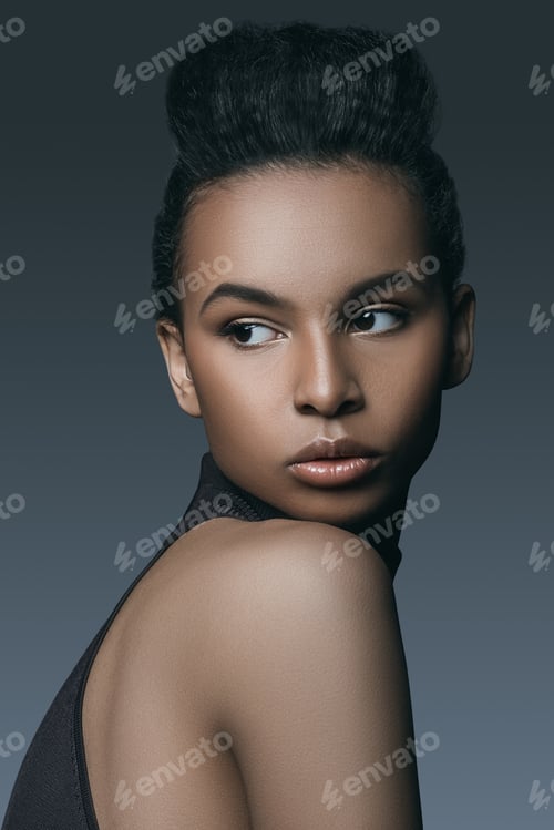 Preview: beautiful elegant african american model posing for fashion shoot, isolated on grey