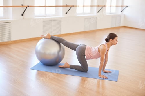 Preview: Slim girl practicing with exercise ball