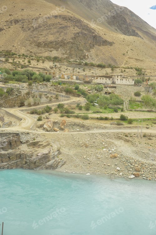 Preview: Beautiful view of Ladakhi traditional buildings with flowing Indus river (Sindhu Nadi)