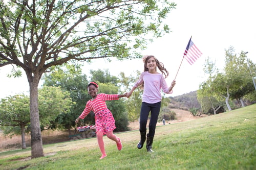 Preview: Children playing with American flag in park