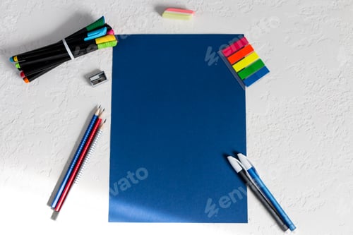 Preview: blank sheet of paper, pencils, eraser, sharpeners and colored stickers on a white background
