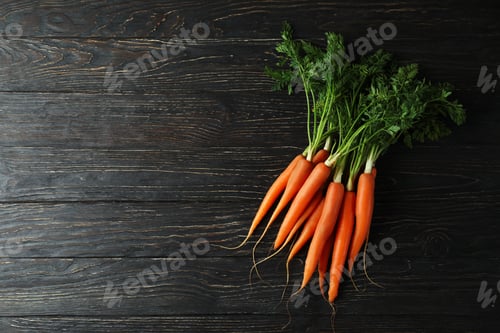 Preview: Heap of fresh carrot on wooden background