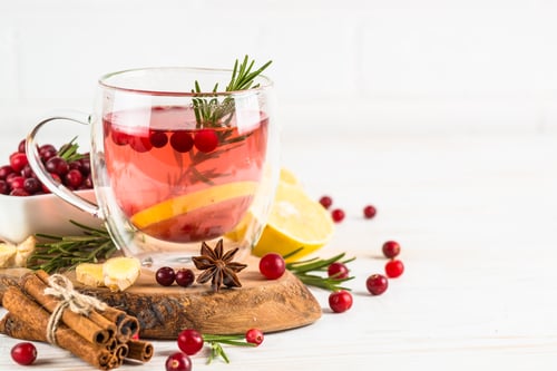 Preview: Cranberry tea with lemon at white table