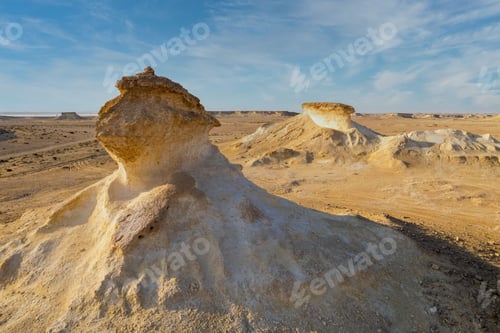 Preview: Zekreet Rock formations in Qatar dessert on a sunny day, clear and sunlit sky in the background