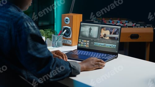 Preview: Video editor analyzing film montage on laptop