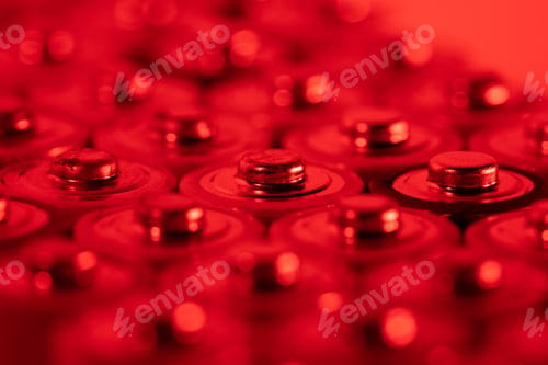 Preview: Closeup of positive ends of discharged batteries AA sizes, macro shot, selective focus. Used battery