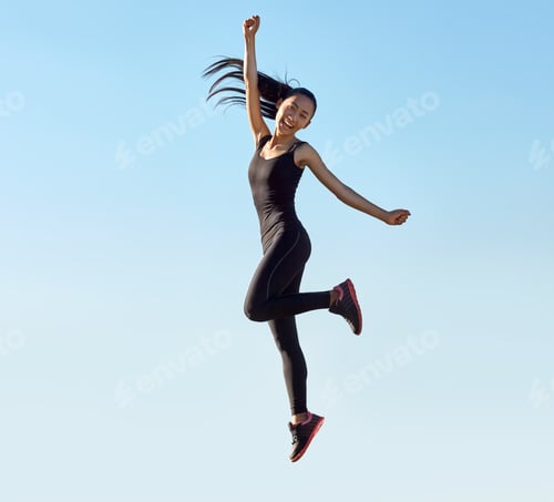Preview: Young sporty asian woman happy jumping outdoors
