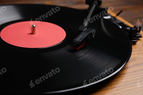 Preview: Modern vinyl record player with disc on table, closeup