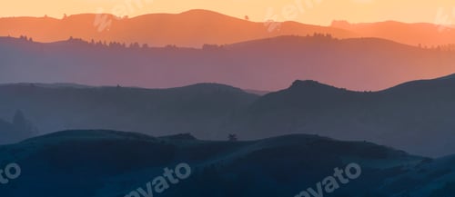 Preview: Sunset view of layered hills and valleys