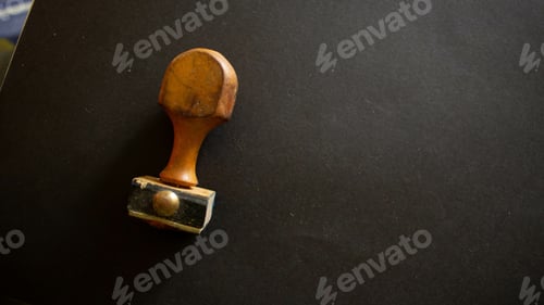 Preview: Closeup shot of a rubber stamper on a black surface