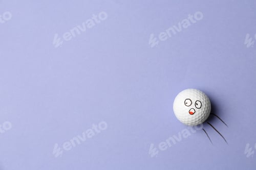 Preview: Golf ball with funny face flying on lilac background - creative image. Top view
