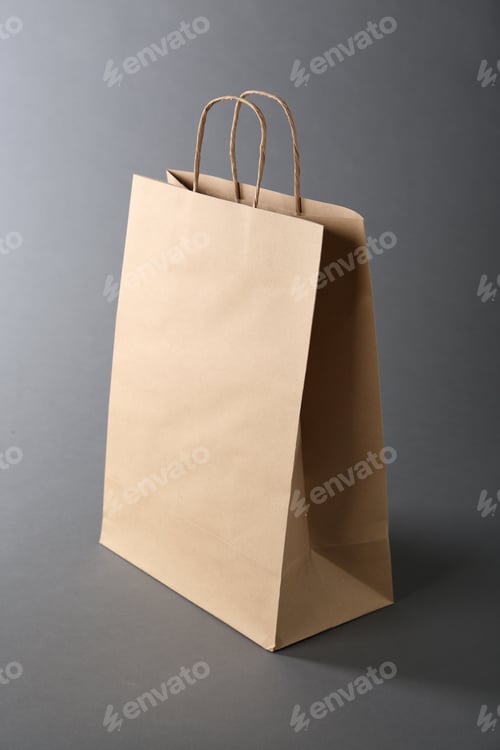 Preview: One kraft paper bag on grey background. Mockup for design